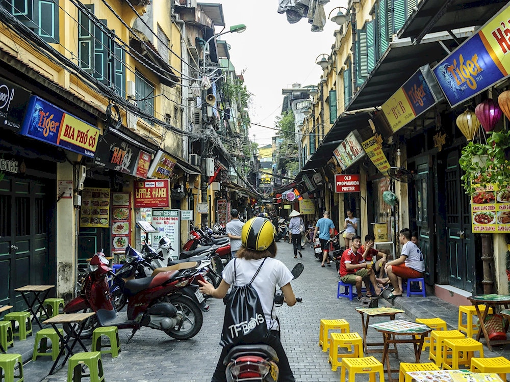 Visitors can enjoy local snacks and cold beer while soaking up the vibrant energy of Ta Hien Beer Street